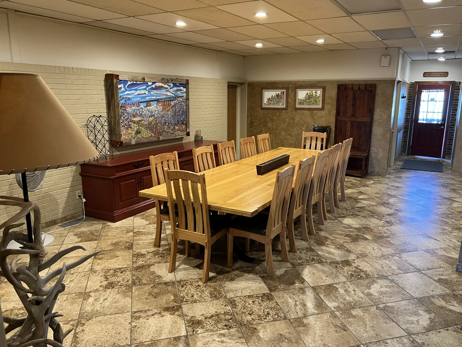 The Last Buffalo lodge dining room with a long wooden table, photographed in 2022